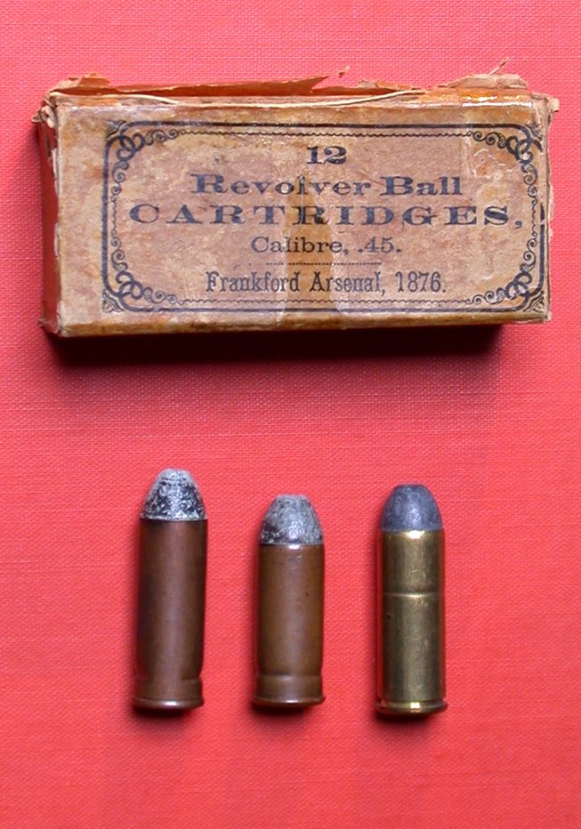 Frankford Arsenal 1876 box of .45 revolver cartridges with three rounds standing below it