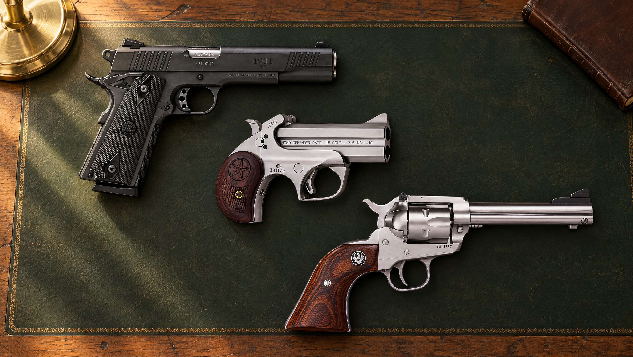 A black 1911 semi-automatic pistol, a stainless Bond Arms derringer and a stainless Ruger Single-Six revolver lying on a green leather desk blotter