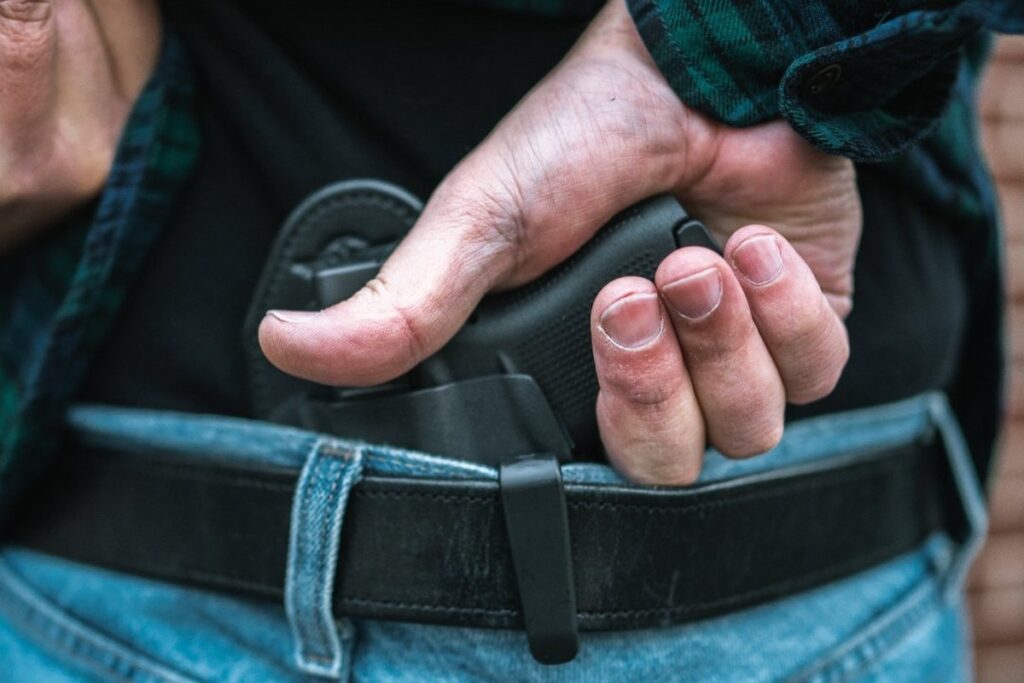Palm-out draw from a Hidden Hybrid Holsters small of the back holster