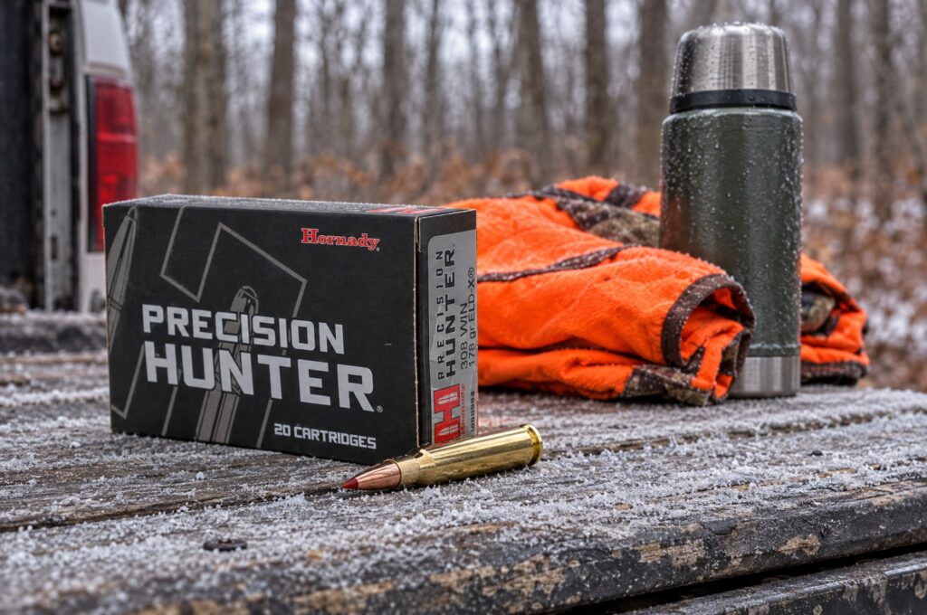 Box of Hornady Precision Hunter 308 Win 178 gr ELD-X with a cartridge on a frosty pickup tailgate