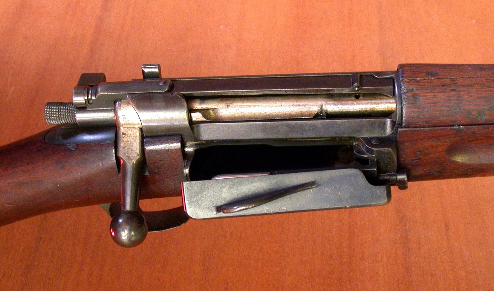 Krag rifle with its side loading gate open, showing the magazine well