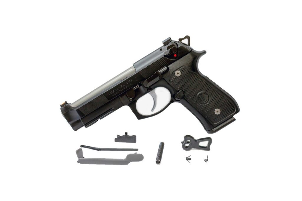 Langdon Tactical Trigger Job in a Bag parts laid out below a Beretta 92