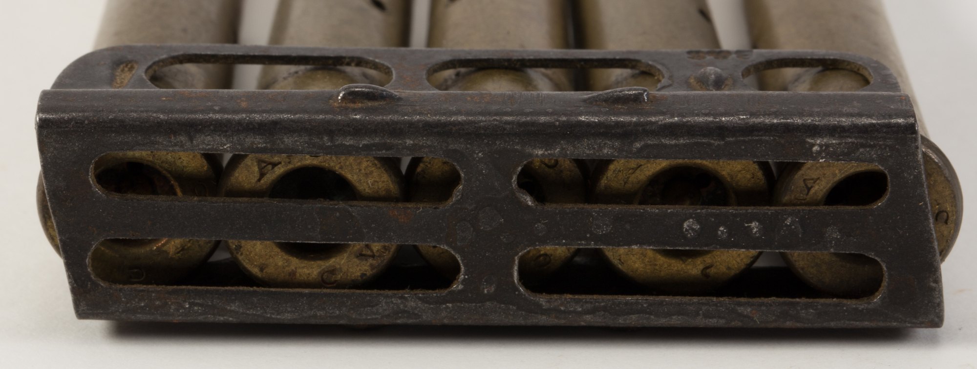 Base of a Lee-Enfield charger showing five cartridge rims overlapping each other
