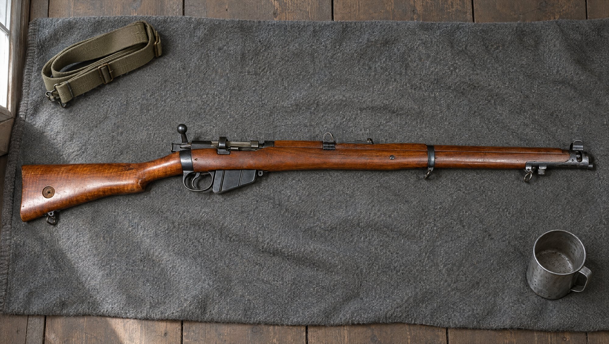 Lee-Enfield No. 1 Mk III rifle lying on a gray wool army blanket
