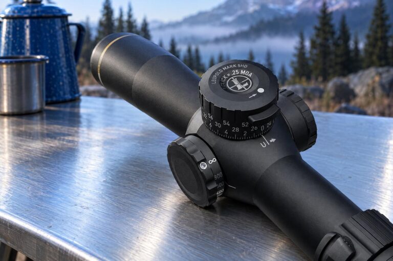 Leupold scopes explained: the Mark 5HD 5-25x56 M1C3 elevation turret, 1 click = .25 MOA, on a steel camp kitchen table at a mountain campsite