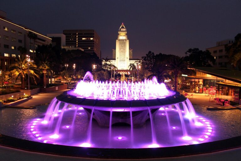 Los Angeles City Hall lit at night behind the Grand Park fountain, where the council repealed the handgun limit