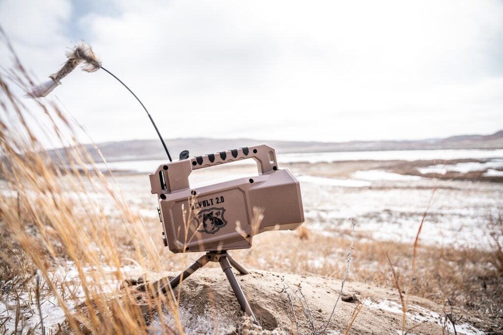 Lucky Duck Revolt 2.0 electronic predator call with its decoy wand set on a snowy prairie rise
