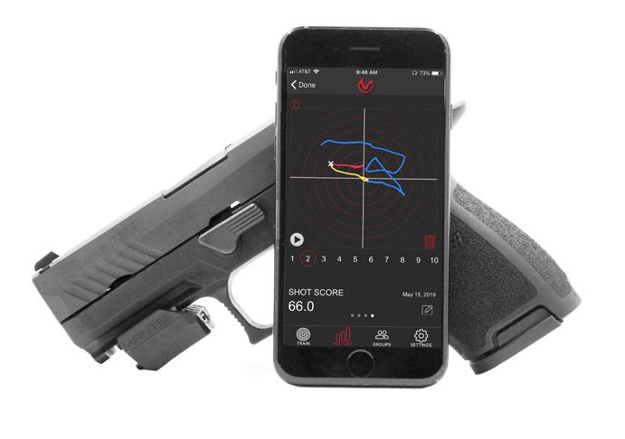 Mantis X3 sensor on a pistol beside a phone showing the shot trace