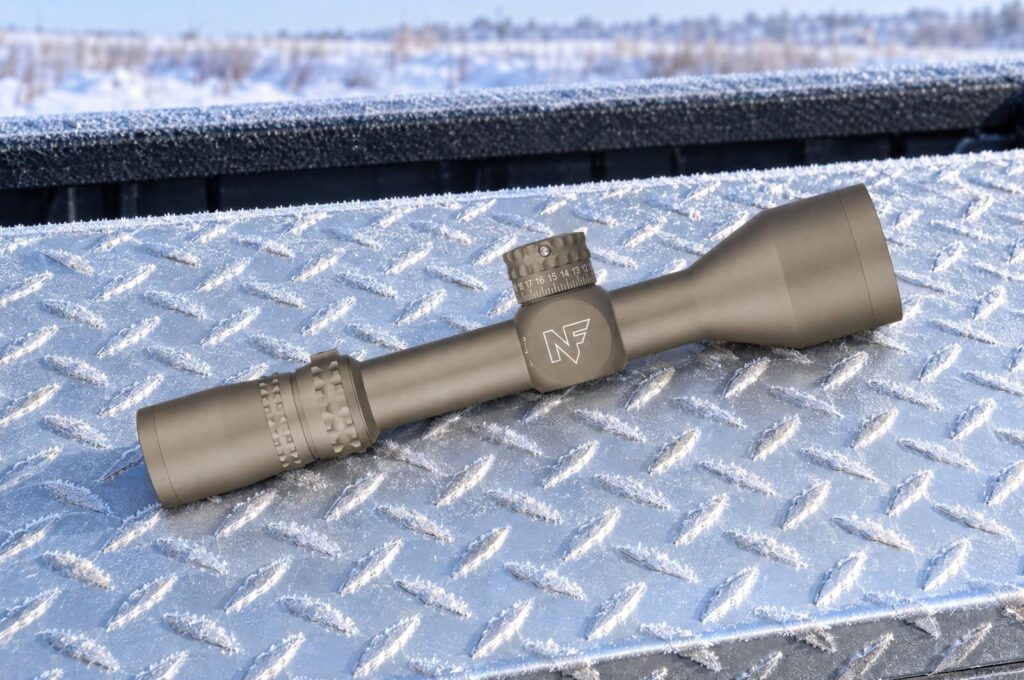 Nightforce NX8 2.5-20x50 F2 second focal plane riflescope in Dark Earth lying on a frosted diamond-plate truck toolbox