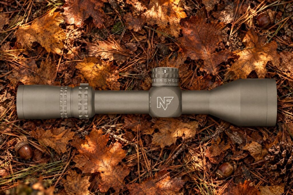 Dark Earth Nightforce NX8 2.5-20 power second focal plane hunting scope lying on dry oak leaves