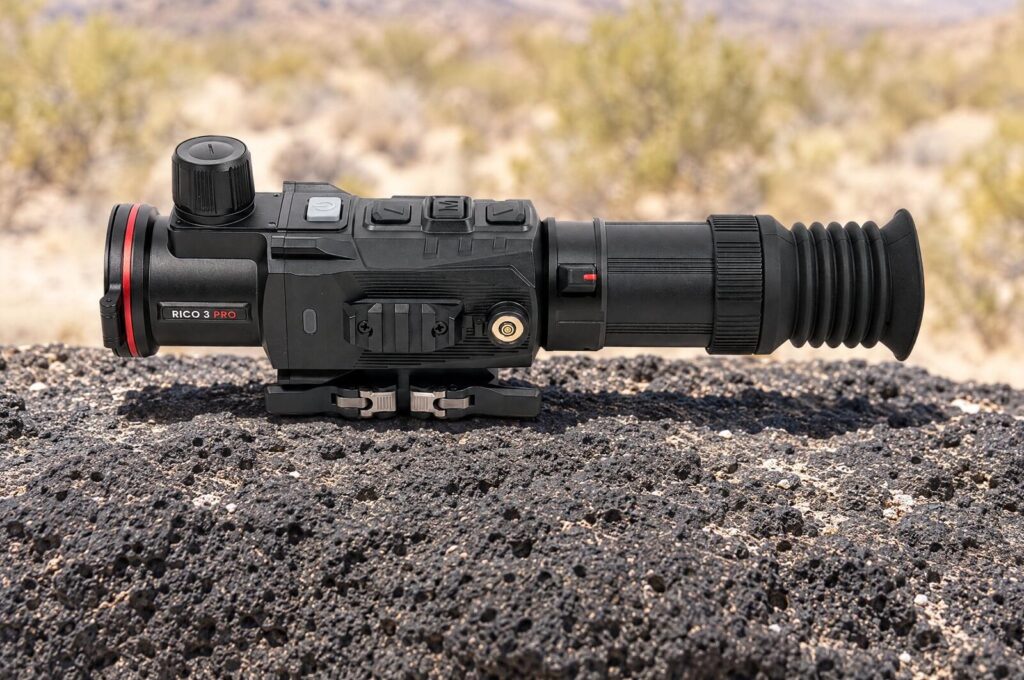 Nocpix Rico 3 Pro H50R thermal weapon sight with autofocus resting on black volcanic rock under midday sun
