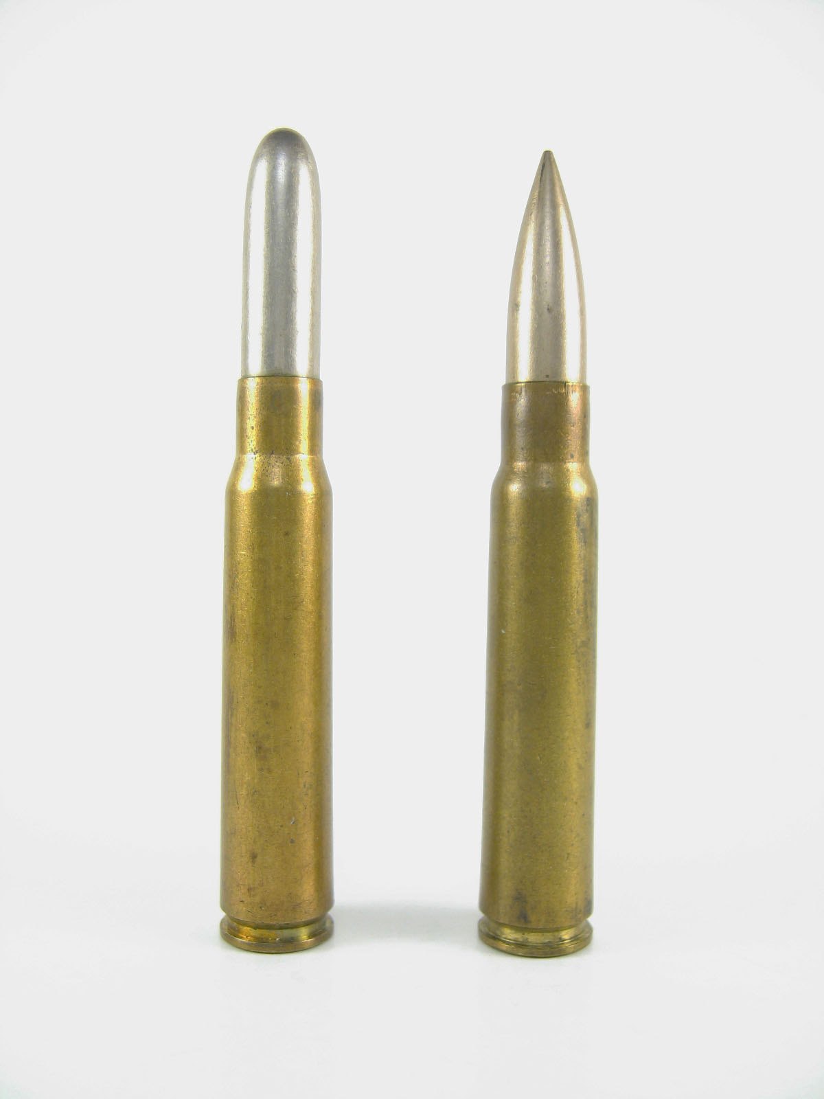 Round-nosed 1888 Patrone 88 cartridge beside a pointed 8mm Mauser S cartridge