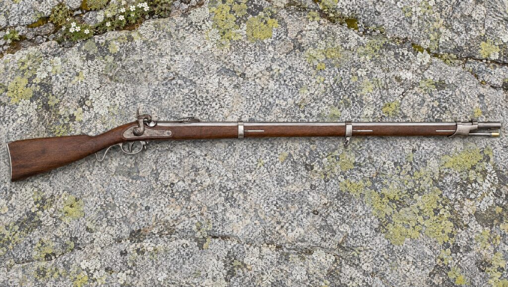 Pedersoli 1857 Wurttembergischen percussion infantry rifle lying flat on a lichen-patched granite slab
