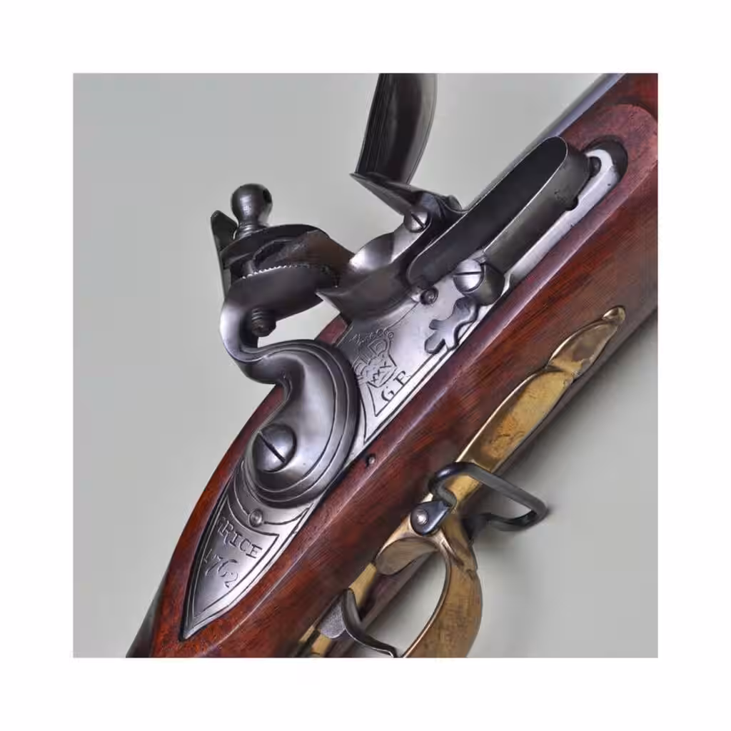 Flintlock of the Pedersoli Brown Bess reproduction, signed Grice with a crown over GR and a brass trigger guard