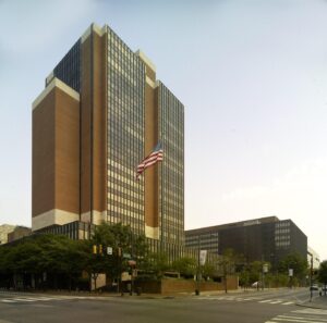 James A. Byrne U.S. Courthouse in Philadelphia, a brick and glass tower with a US flag out front