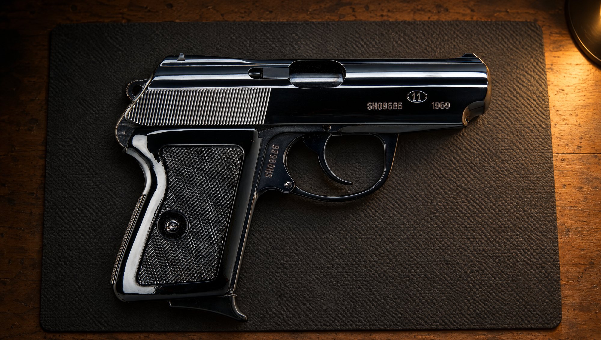 Polish P-64 pistol in 9x18 Makarov lying on a gray bench mat