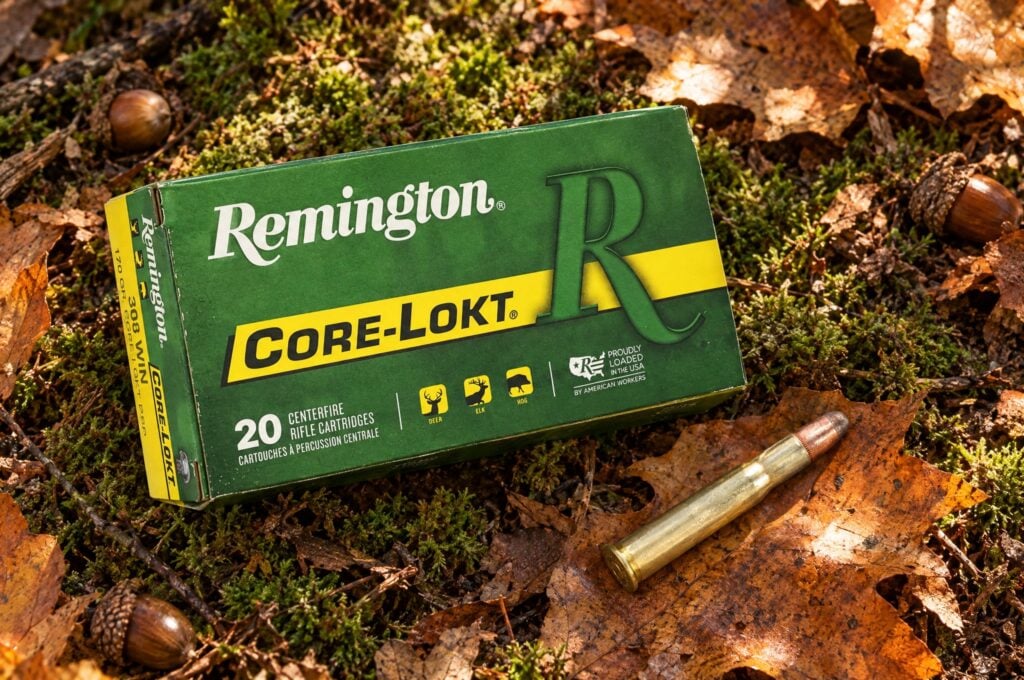 Remington Core-Lokt 30-30 Win 170 grain soft point box and cartridge on moss and oak leaves on the forest floor
