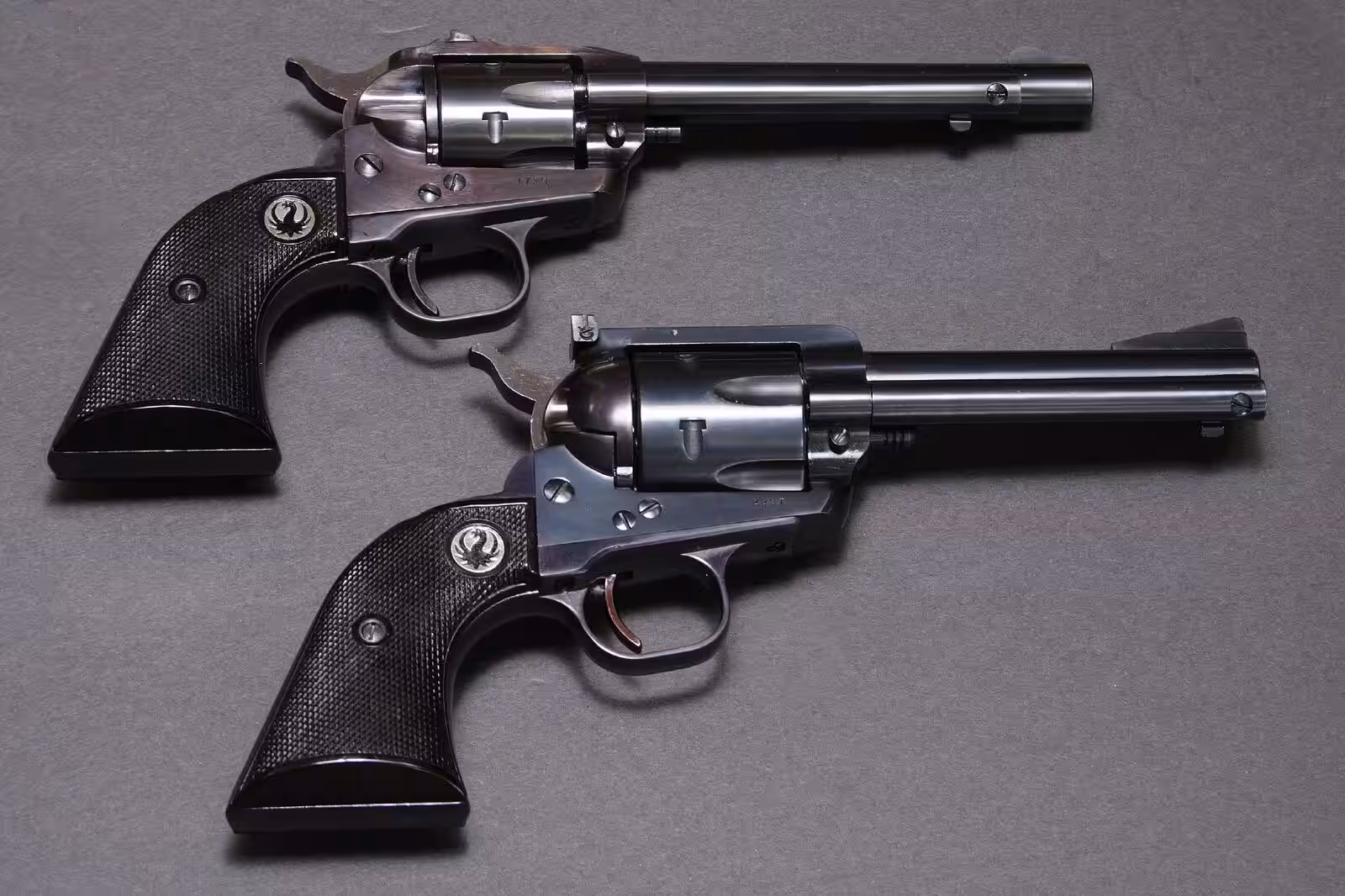 Early Ruger Single-Six serial 1715 above an early Ruger Blackhawk flat top serial 2237, both shown from the right side
