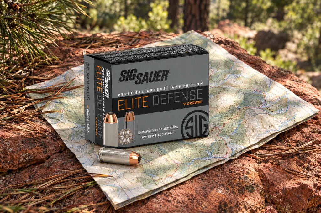 Sig Sauer Elite Defense V-Crown 10mm Auto 180 grain JHP box and cartridge on a trail map over sandstone