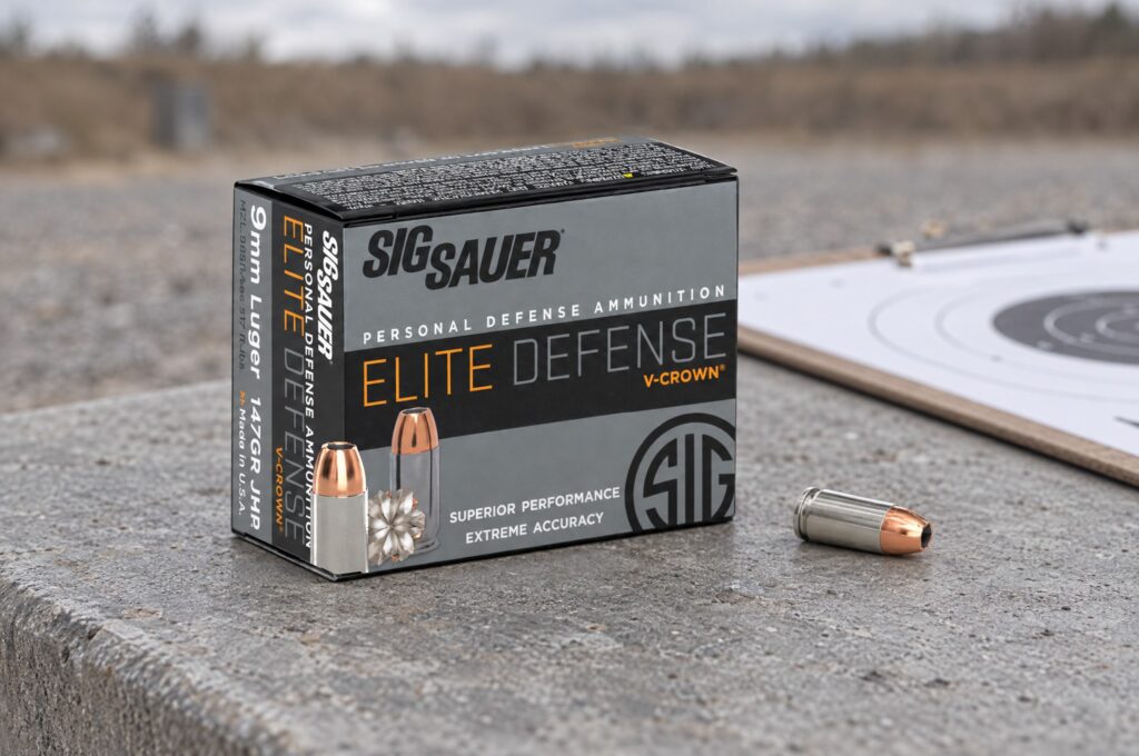 Sig Sauer Elite Defense V-Crown 9mm Luger 147 grain JHP box and cartridge on a concrete range bench beside a target clipboard