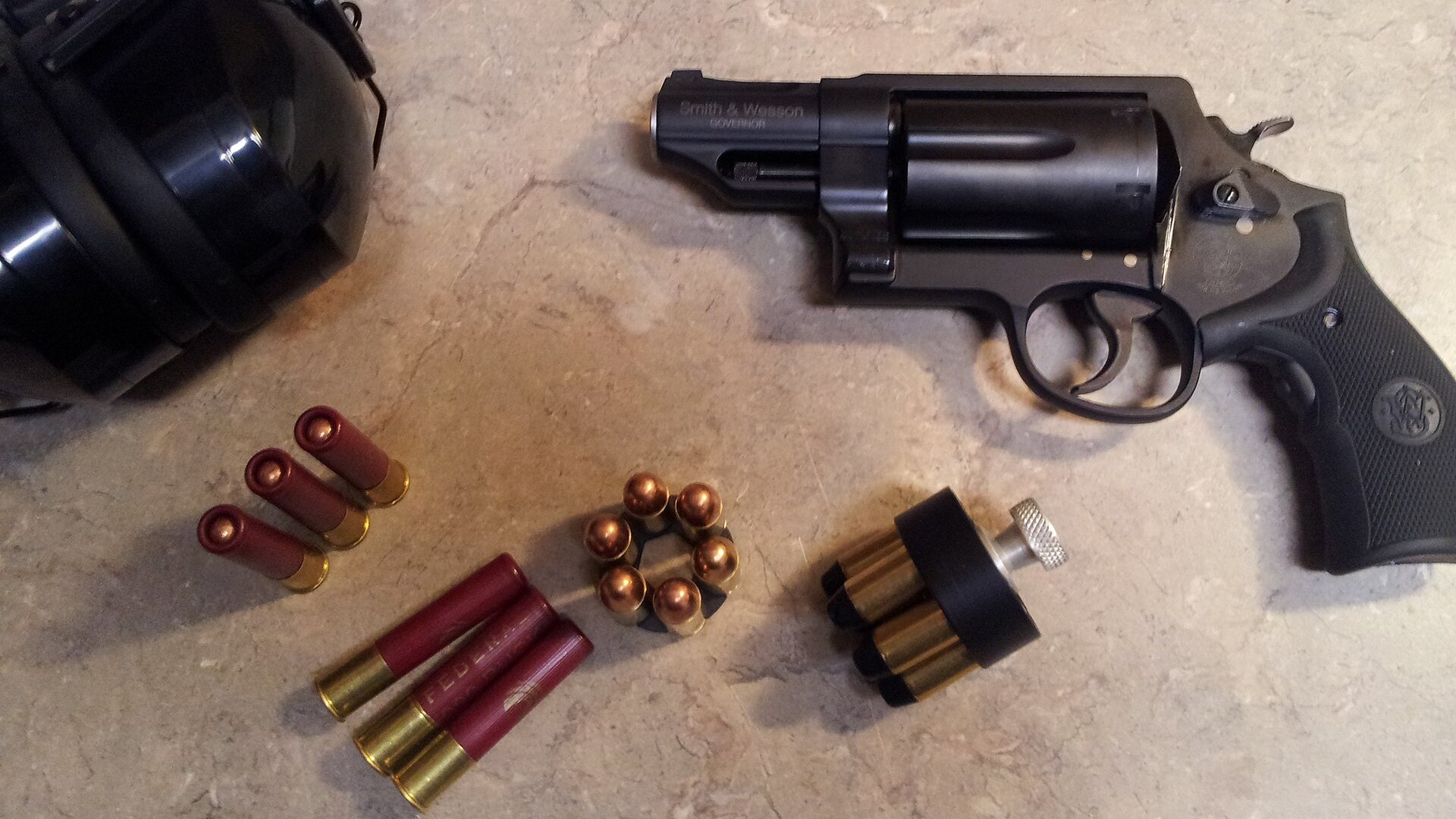 Smith and Wesson Governor revolver with 45 Colt cartridges, 45 ACP in a moon clip and .410 shotshells