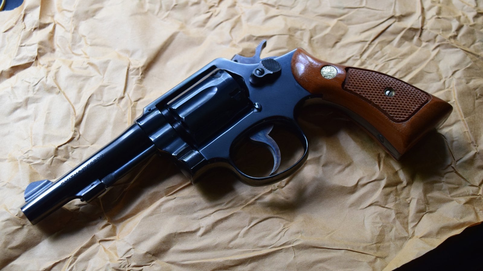 Blued Smith and Wesson Model 10 revolver with 4 inch heavy barrel, fixed sights and wood Magna stocks