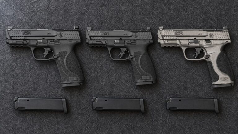 Smith & Wesson M&P M2.0 models compared: black M&P9 M2.0 Full Size, black M&P9 M2.0 Compact and gray M&P9 M2.0 Metal lying flat on a gray felt mat
