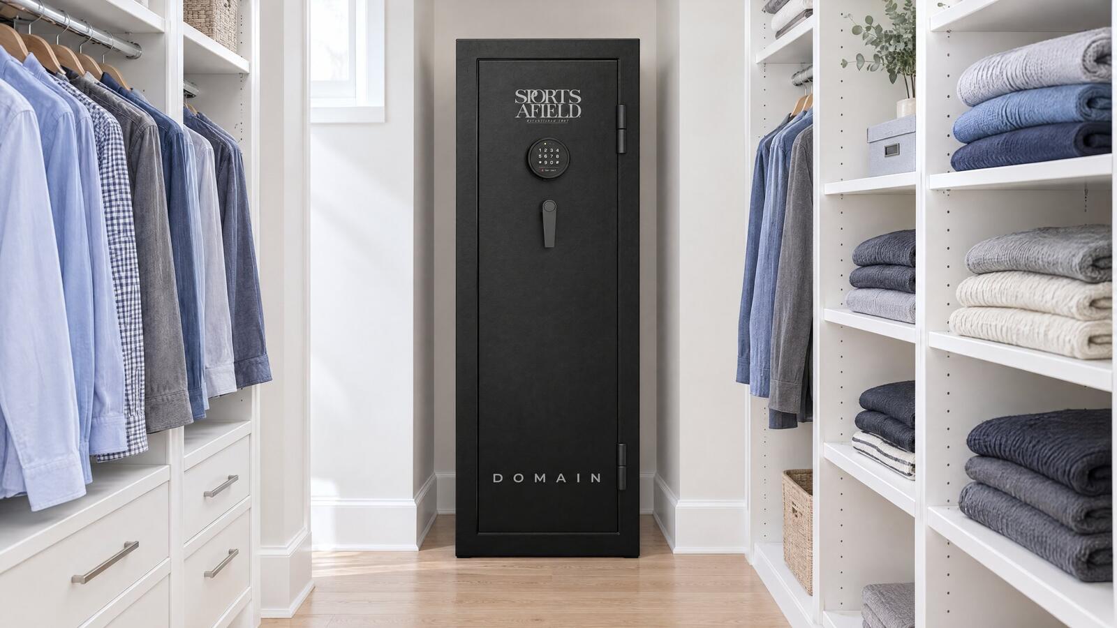 Black Sports Afield Domain 20 gun safe with an electronic keypad standing in a narrow alcove of a bright walk-in closet