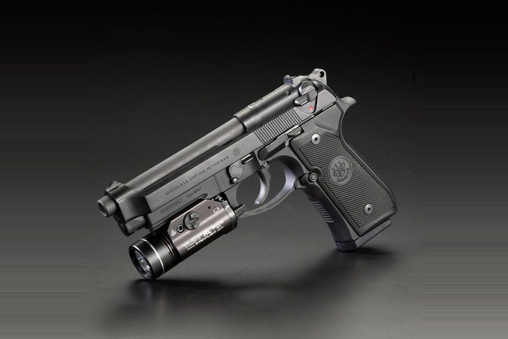 Streamlight TLR-1 HL weapon light mounted on the accessory rail of a Beretta M9A1 pistol