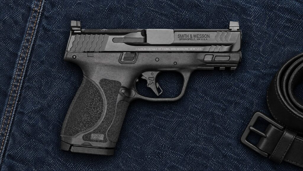 Smith & Wesson M&P9 M2.0 Compact 3.6 inch Optics Ready pistol lying flat on dark blue denim