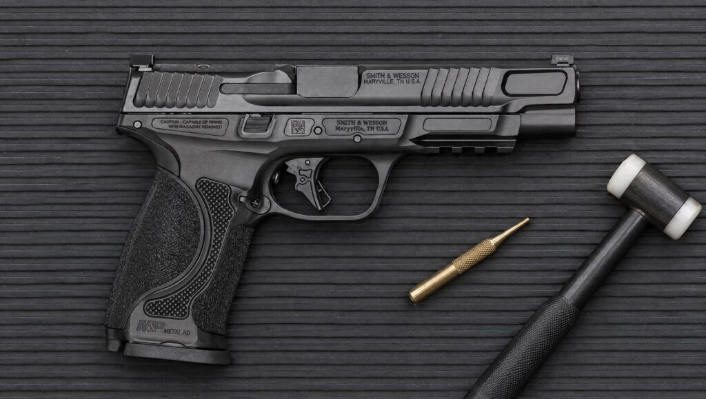 Smith & Wesson M&P9 M2.0 Metal HD pistol with 5 inch barrel and black stainless steel frame lying flat on a rubber bench mat