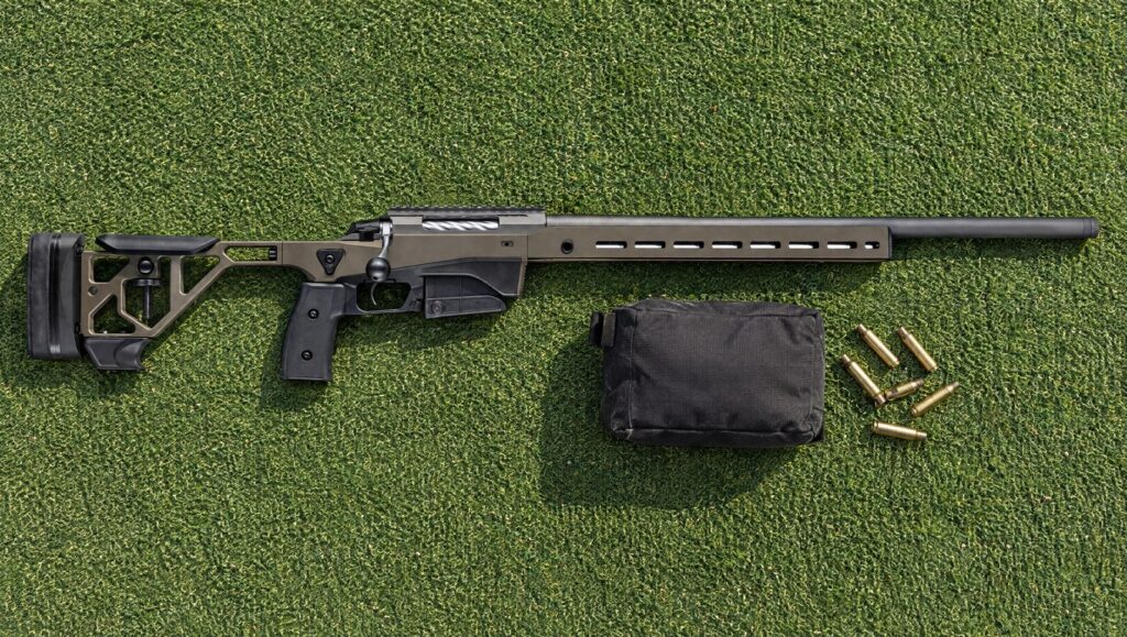 Tikka T3x Ace Target chassis rifle with heavy barrel and 20 MOA rail lying flat on a green range mat
