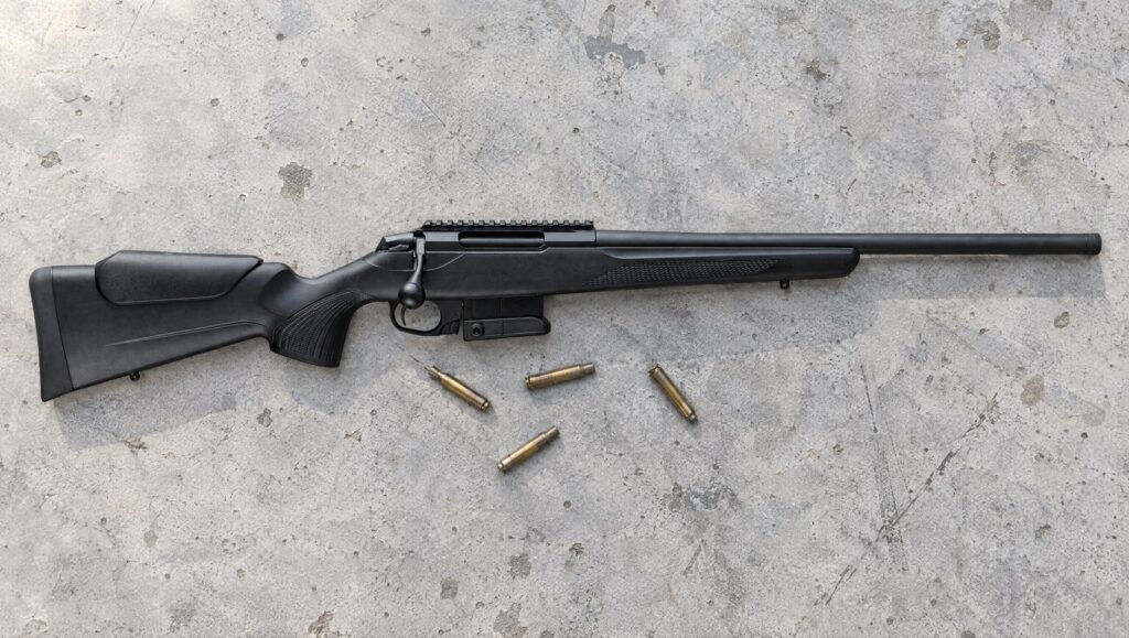 Tikka T3x CTR Compact Tactical Rifle with Picatinny rail and 10-round steel magazine lying flat on a concrete bench