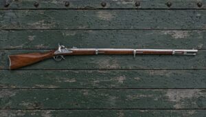 Traditions 1861 Springfield percussion rifle-musket lying flat on the green painted bed of a farm wagon in light rain