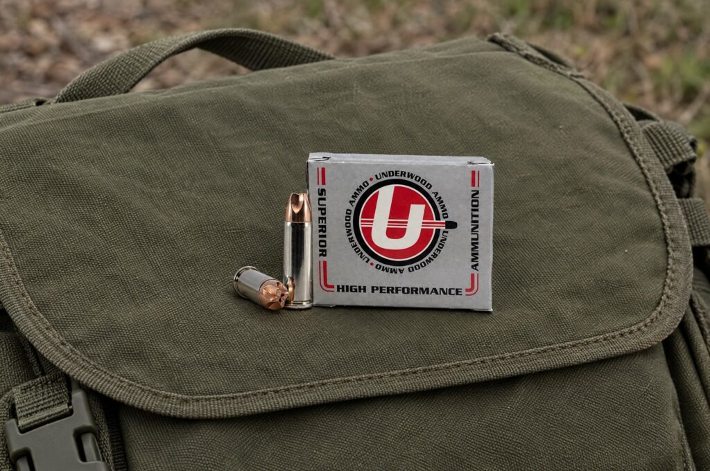 Underwood Xtreme Defender 38 Special +P 100 grain box and cartridges on an olive drab canvas range bag