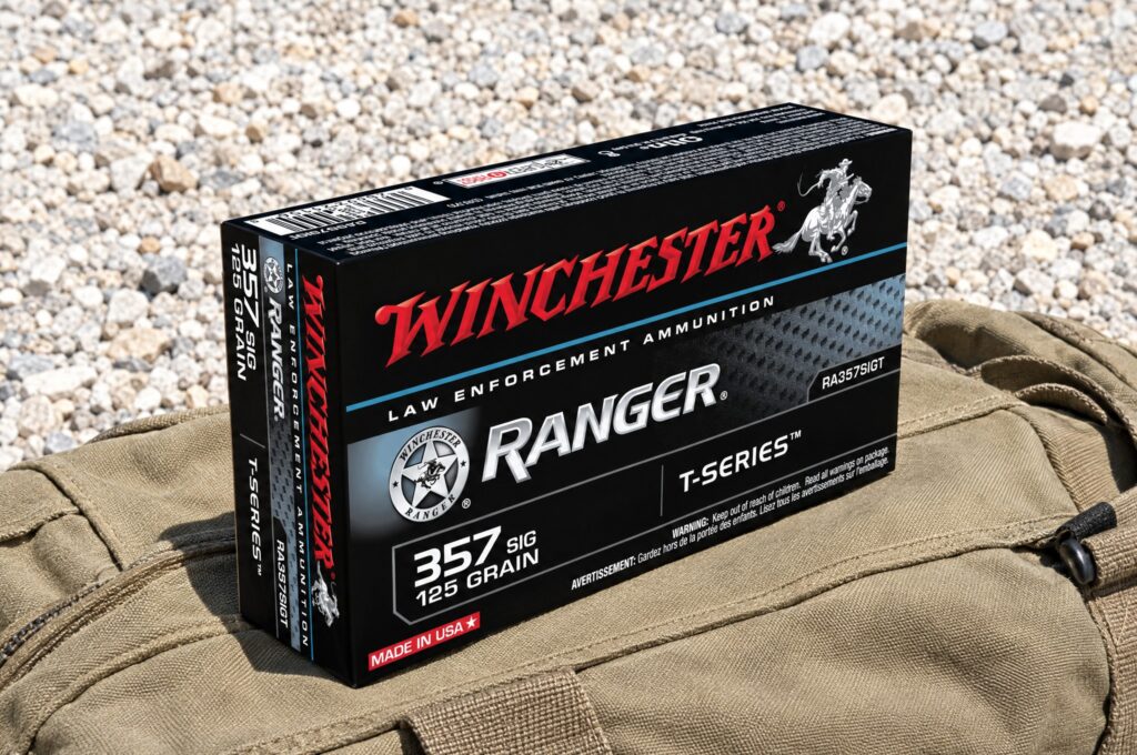Winchester Ranger T-Series RA357SIGT 357 Sig 125 grain box on a khaki canvas duffel in noon sun